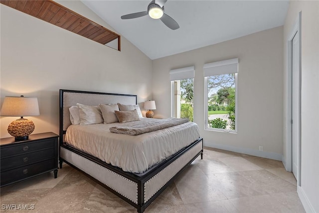 bedroom featuring a ceiling fan, vaulted ceiling, and baseboards