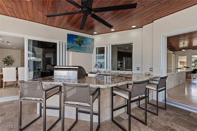 view of patio / terrace featuring outdoor wet bar, ceiling fan, grilling area, and area for grilling