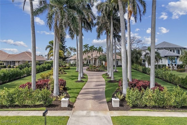 view of home's community with a residential view and a yard