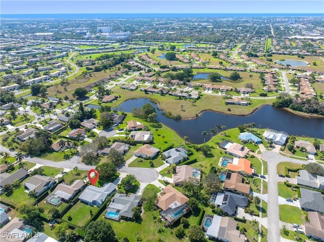 birds eye view of property with a water view and a residential view