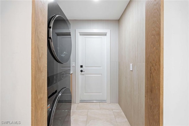 laundry area with stacked washing maching and dryer