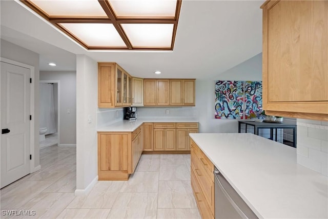 kitchen featuring light brown cabinets, recessed lighting, light countertops, dishwasher, and glass insert cabinets