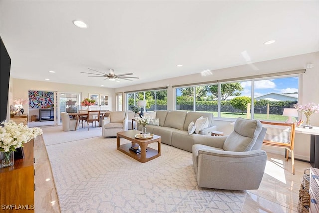 living room featuring ceiling fan, plenty of natural light, and recessed lighting