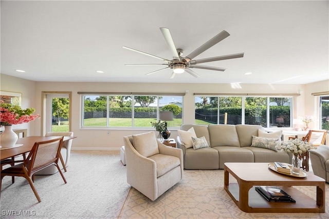 living room with light carpet, ceiling fan, recessed lighting, and a healthy amount of sunlight