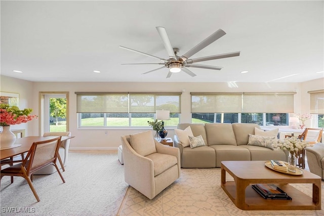 living room featuring baseboards, recessed lighting, a ceiling fan, and light colored carpet