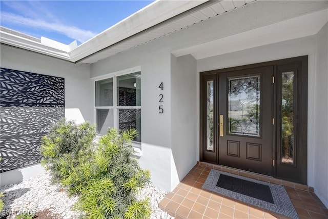 property entrance with stucco siding