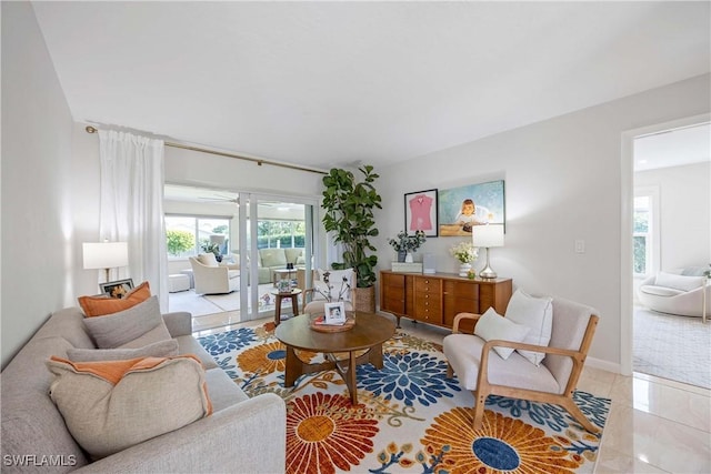 living area with light tile patterned flooring and baseboards