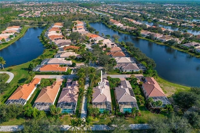 drone / aerial view featuring a water view and a residential view