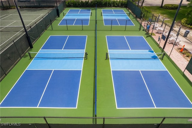 view of tennis court featuring fence