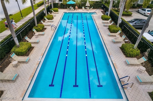 pool featuring a patio area and fence