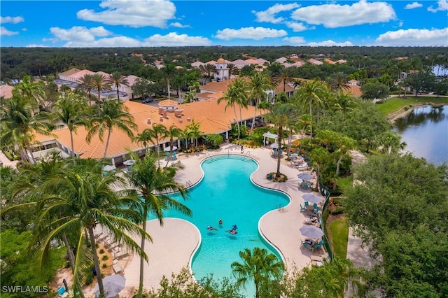 pool with a patio and a water view