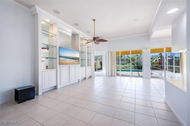 unfurnished living room with ceiling fan, built in shelves, crown molding, and light tile patterned flooring