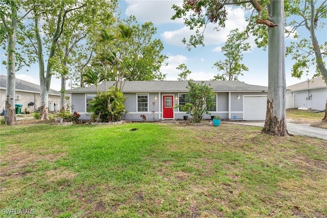 single story home featuring a front lawn, concrete driveway, and an attached garage