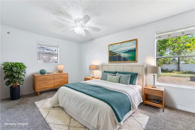 bedroom with carpet floors, multiple windows, and a ceiling fan