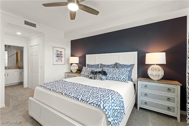 bedroom with carpet floors, crown molding, visible vents, an accent wall, and a ceiling fan