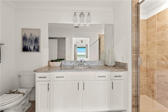 bathroom featuring a ceiling fan, toilet, crown molding, vanity, and a shower stall