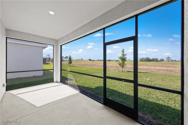 unfurnished sunroom with a rural view