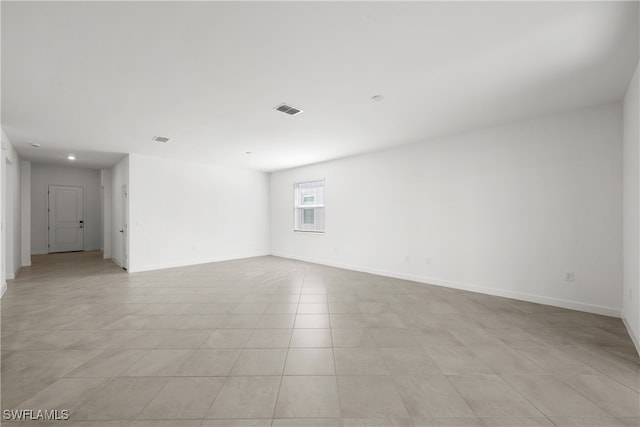 spare room featuring baseboards and visible vents