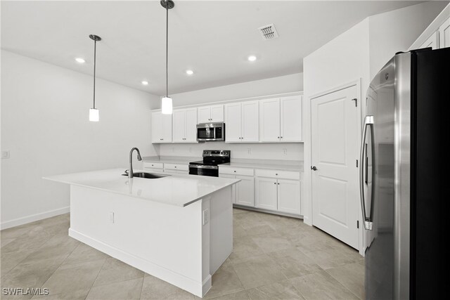 kitchen with a sink, light countertops, appliances with stainless steel finishes, a center island with sink, and pendant lighting