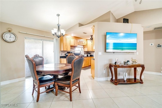 dining area featuring a healthy amount of sunlight, light tile patterned floors, and vaulted ceiling