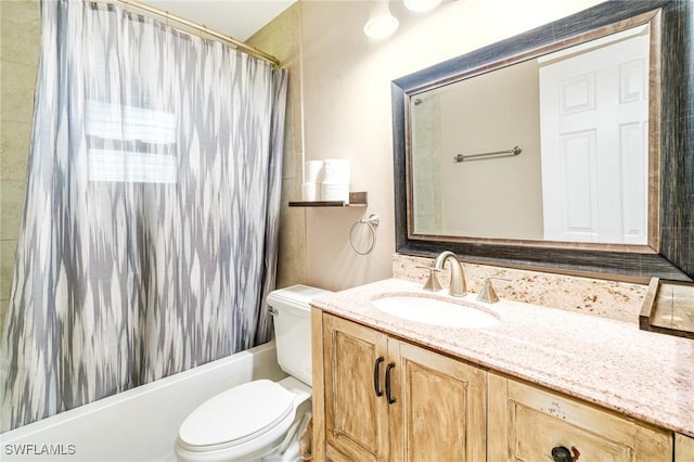 full bath featuring shower / bath combo, vanity, and toilet