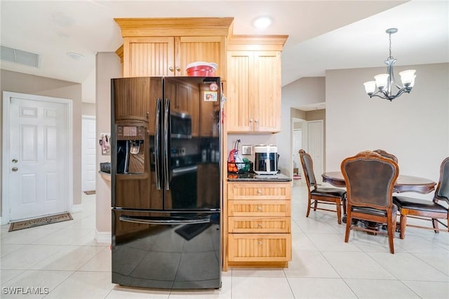 kitchen featuring light tile patterned floors, black fridge with ice dispenser, lofted ceiling, an inviting chandelier, and light brown cabinetry