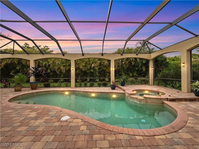 view of swimming pool with a lanai, a patio area, and a pool with connected hot tub