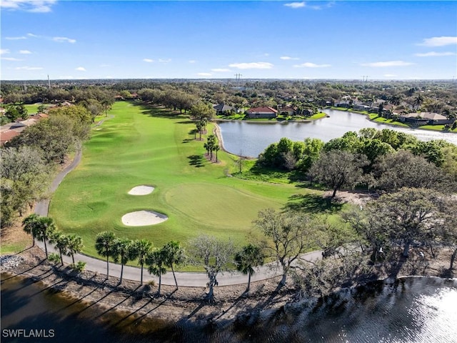 birds eye view of property featuring view of golf course and a water view