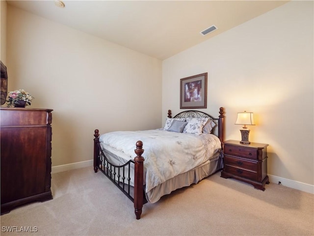 bedroom featuring visible vents, light carpet, and baseboards