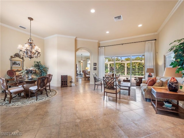 dining area with arched walkways, ornamental molding, visible vents, and baseboards