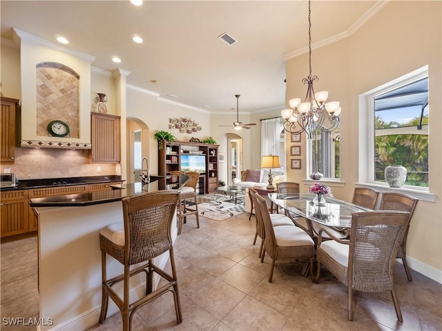 dining area with arched walkways, light tile patterned floors, ornamental molding, and visible vents