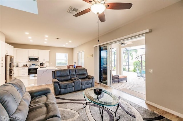 living area with light tile patterned flooring, baseboards, visible vents, and recessed lighting