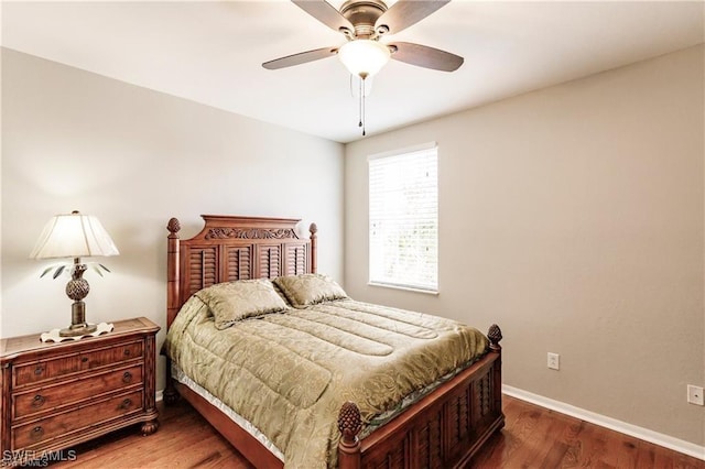 bedroom featuring a ceiling fan, baseboards, and wood finished floors