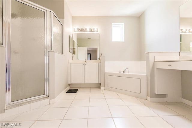 full bath with a stall shower, tile patterned flooring, a bath, and vanity