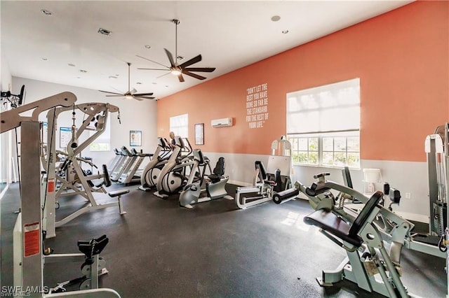 exercise room featuring a ceiling fan, baseboards, visible vents, and an AC wall unit