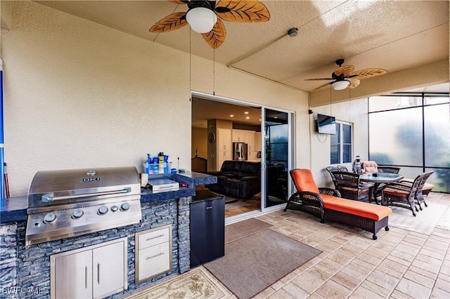 view of patio / terrace featuring exterior kitchen, outdoor dining space, and a grill