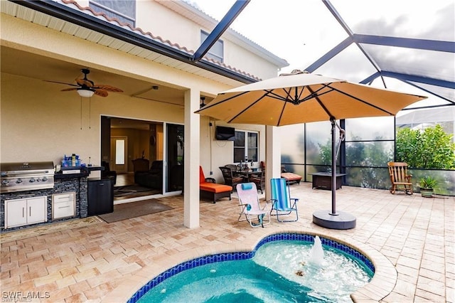 view of pool featuring grilling area, an outdoor kitchen, a ceiling fan, a patio area, and a lanai