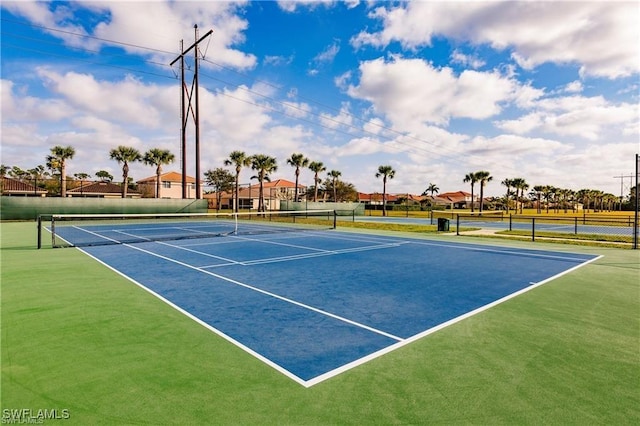 view of sport court featuring fence