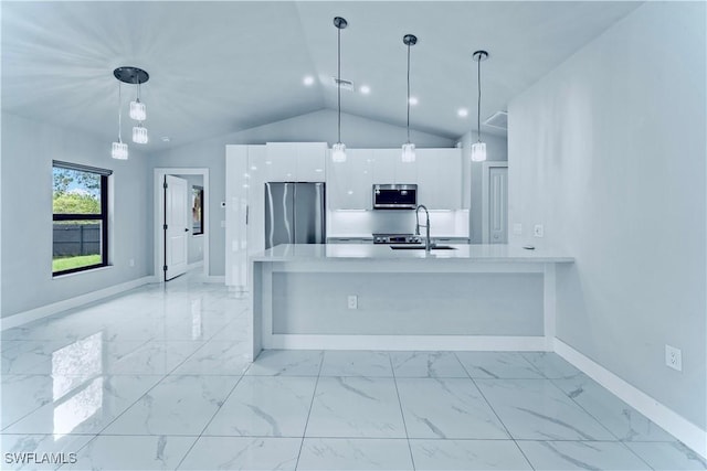 kitchen with stainless steel appliances, light countertops, hanging light fixtures, white cabinetry, and a sink