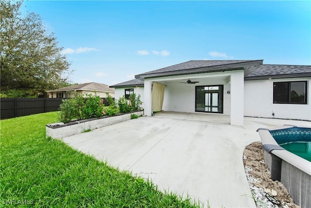 back of house with a patio, fence, a ceiling fan, a lawn, and stucco siding