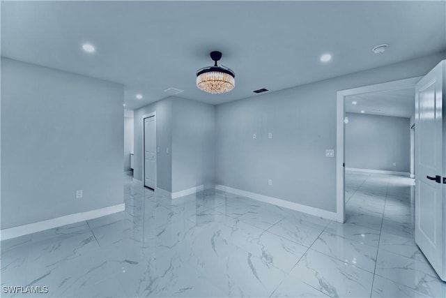 unfurnished room with marble finish floor, recessed lighting, visible vents, and baseboards