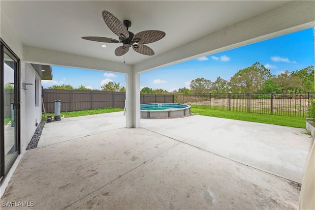 view of patio featuring a fenced backyard, a ceiling fan, and a fenced in pool