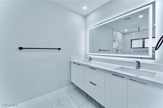 full bath with marble finish floor, a sink, visible vents, and baseboards