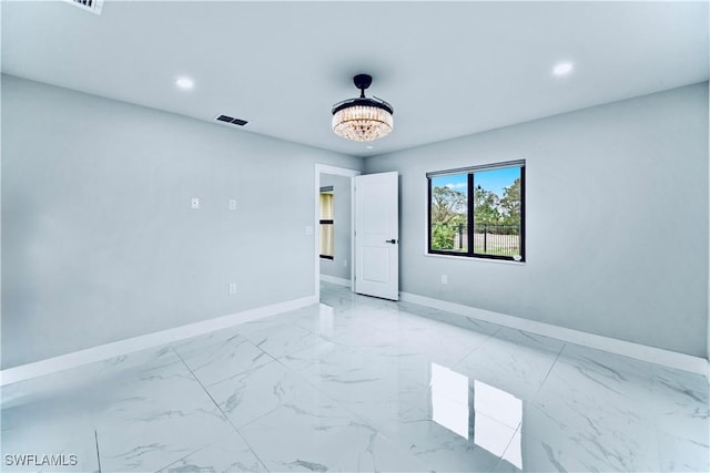 spare room featuring marble finish floor, recessed lighting, visible vents, an inviting chandelier, and baseboards