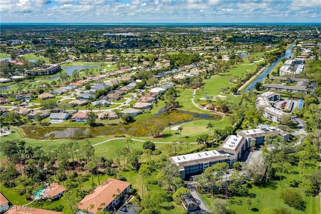 bird's eye view with a residential view, view of golf course, and a water view