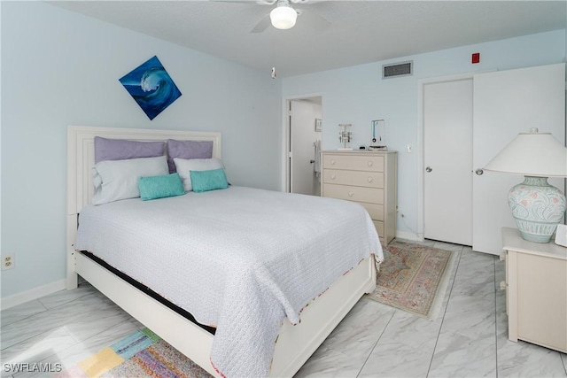 bedroom with a ceiling fan, marble finish floor, visible vents, and baseboards