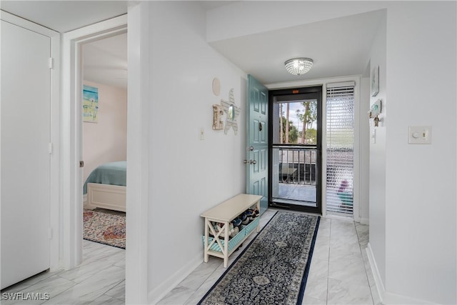 foyer entrance featuring marble finish floor and baseboards