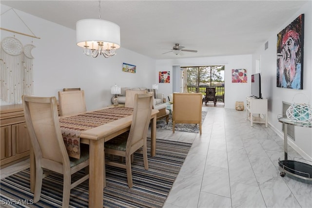 dining area featuring ceiling fan with notable chandelier, marble finish floor, and visible vents