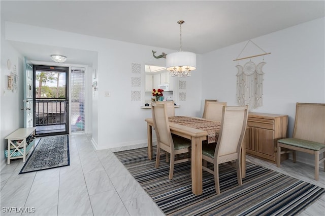 dining area with a notable chandelier, marble finish floor, and baseboards