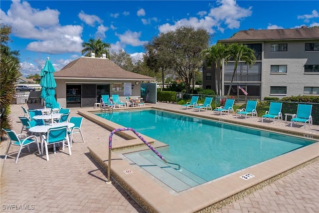 pool featuring a patio area and fence